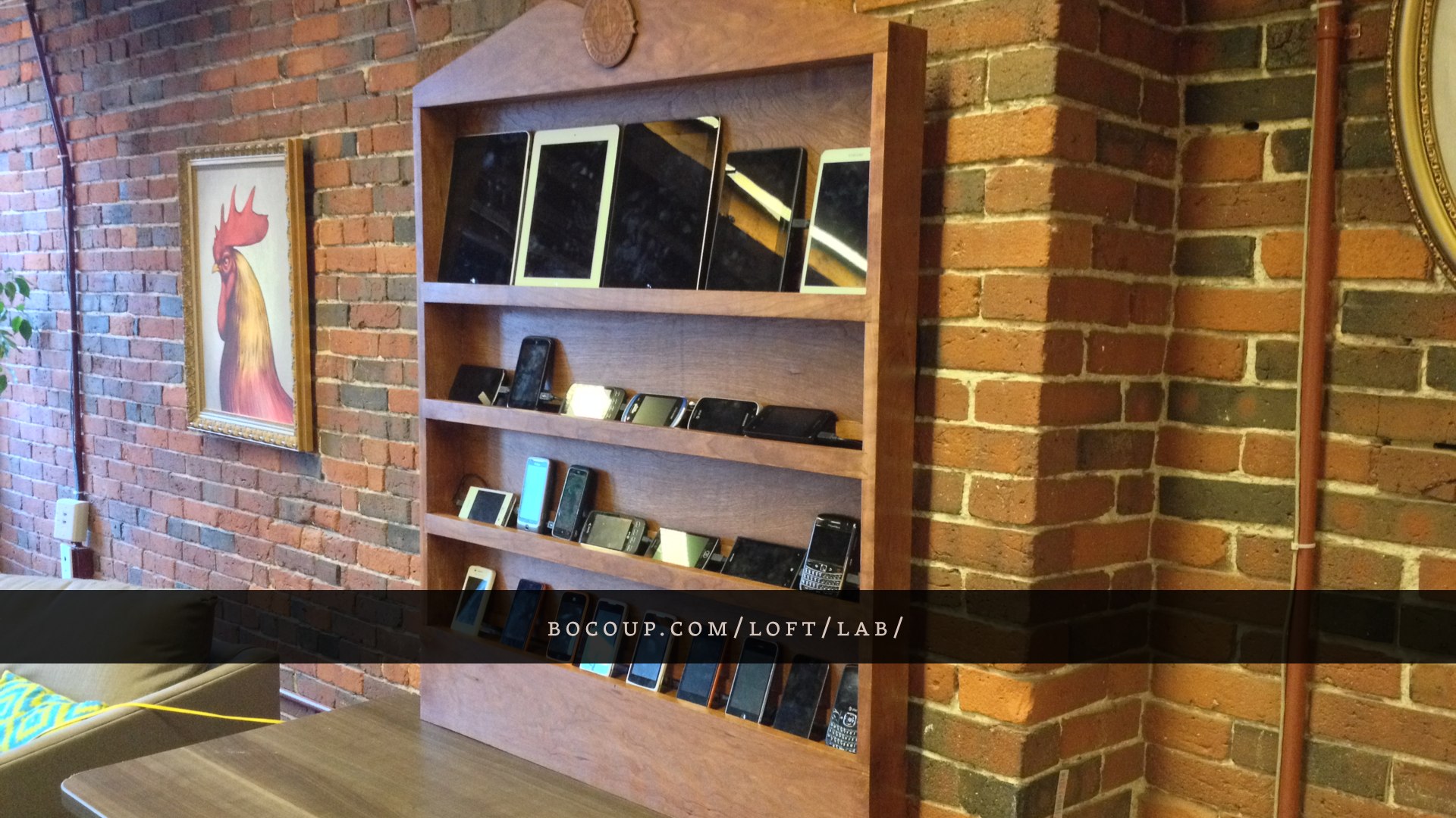 The Bocoup Open Device Lab, a hand-made hardwood shelving unit full of mobile phones and tablets